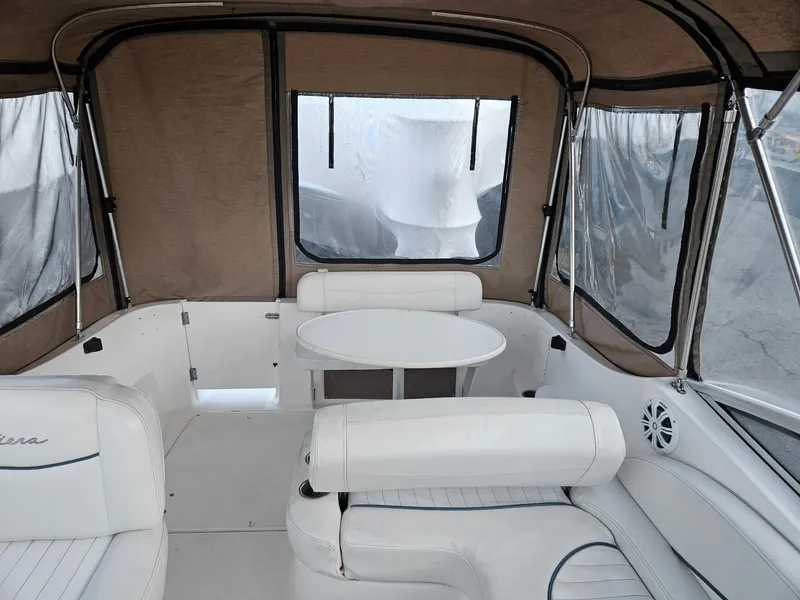 Slide: The Image of 2001 Bayliner 2655 Cierra boat interior with white seating and round table. - 10