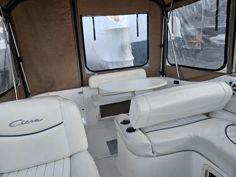 Slide: The Image of 2001 Bayliner 2655 Cierra boat interior with white seating and table. - 11