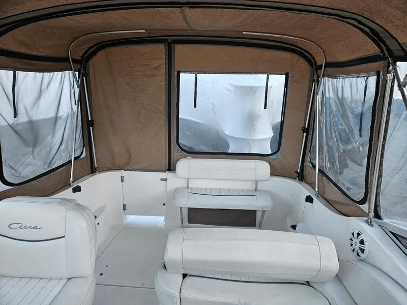 Slide: The Image of 2001 Bayliner 2655 Cierra boat interior with beige canopy and white seating. - 12