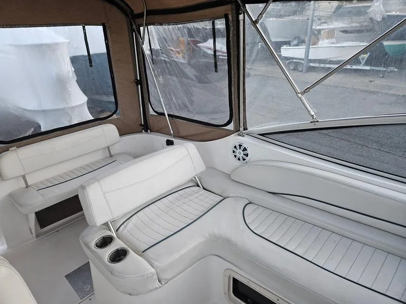 Slide: The Image of 2001 Bayliner 2655 Cierra boat interior with white seating and clear windows. - 14