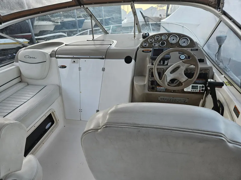 Slide: The Image of 2001 Bayliner 2655 Cierra boat cockpit with steering wheel and dashboard controls. - 16