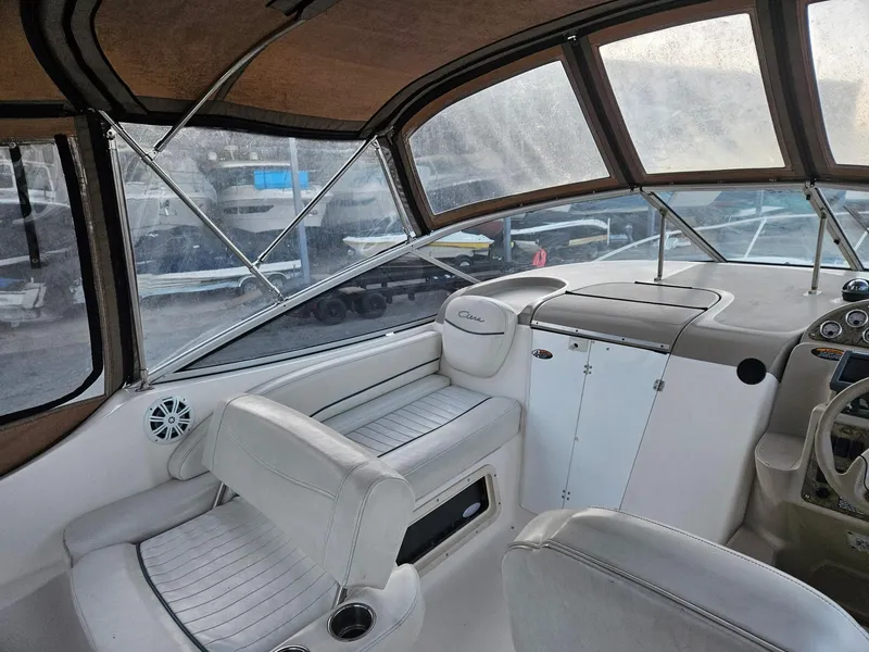Slide: The Image of 2001 Bayliner 2655 Cierra boat interior with white seating and dashboard. - 17