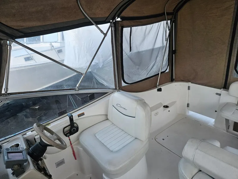 Slide: The Image of 2001 Bayliner 2655 Cierra boat interior with white seating and covered cockpit. - 18