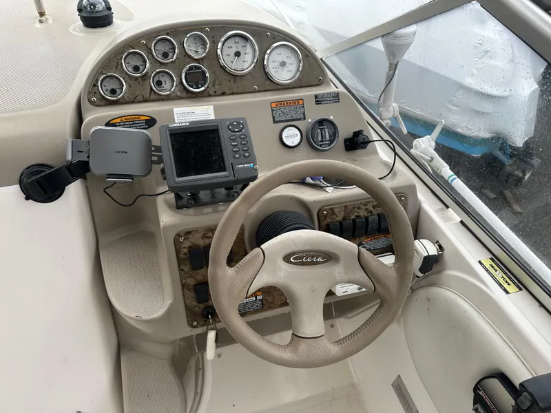 Slide: The Image of 2001 Bayliner 2655 Cierra boat dashboard with steering wheel and navigation instruments. - 20