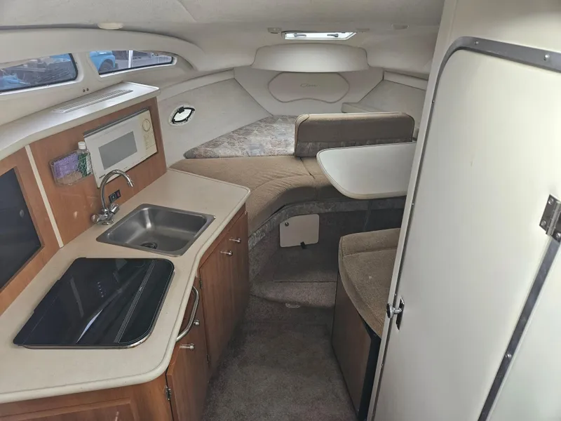 Slide: The Image of 2001 Bayliner 2655 Cierra cabin interior with kitchenette, sink, and seating area. - 24