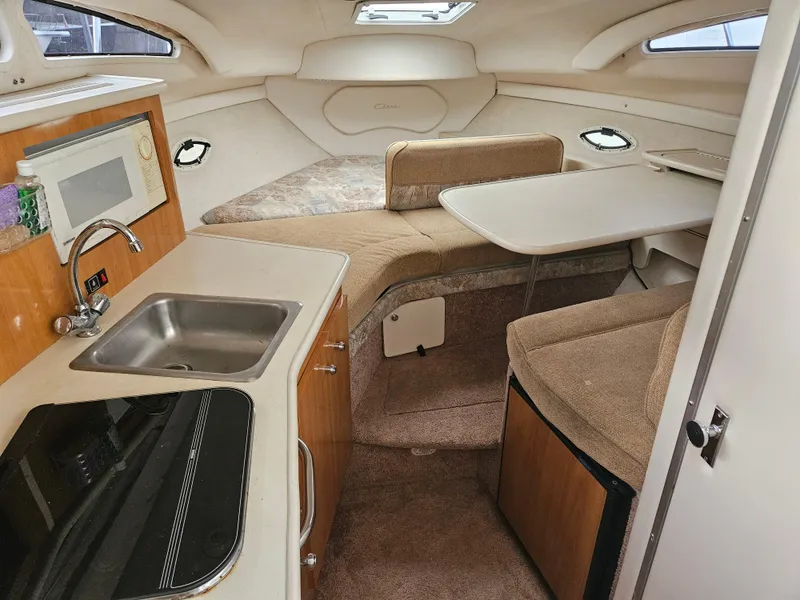 Slide: The Image of 2001 Bayliner 2655 Cierra cabin interior with kitchenette and seating area. - 27