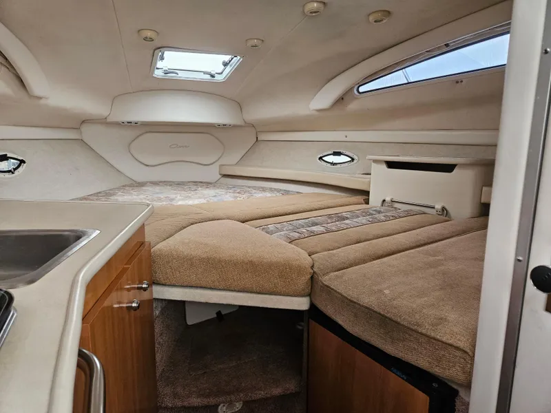 Slide: The Image of Interior of 2001 Bayliner 2655 Cierra boat, featuring cozy cabin and compact kitchenette. - 29