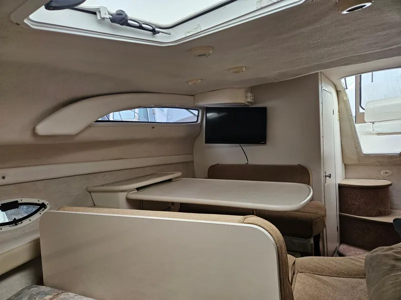 Slide: The Image of Interior of 2001 Bayliner 2655 Cierra boat with seating, table, and TV. - 33