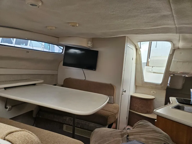 Slide: The Image of Interior of 2001 Bayliner 2655 Cierra boat with seating, table, and mounted TV. - 34