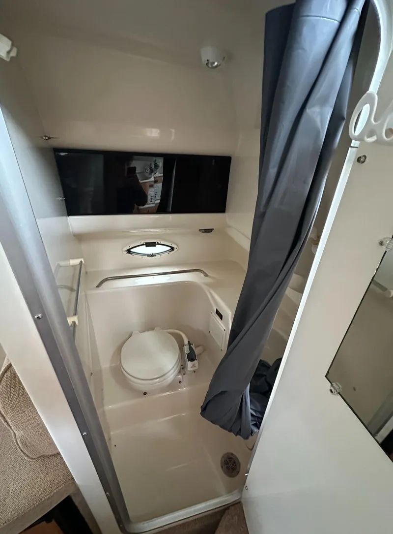 Slide: The Image of 2001 Bayliner 2655 Cierra boat bathroom with shower, toilet, and curtain. - 37