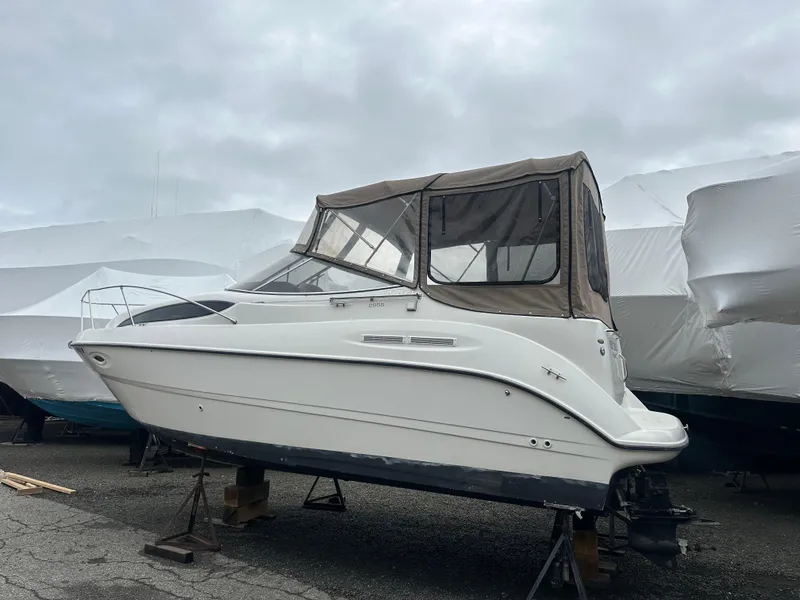 Slide: The Image of 2001 Bayliner 2655 Cierra boat on stands, covered, in storage yard. - 4