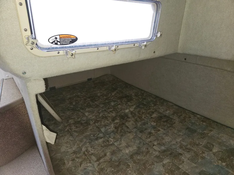 Slide: The Image of Interior cabin of 2001 Bayliner 2655 Cierra boat, featuring a window and carpeted floor. - 40