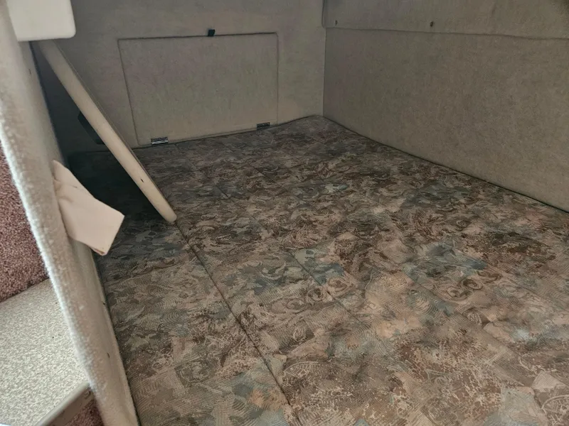 Slide: The Image of 2001 Bayliner 2655 Cierra cabin interior with patterned flooring and compact design. - 41