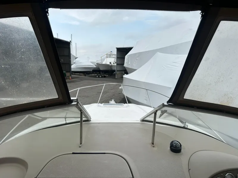 Slide: The Image of 2001 Bayliner 2655 Cierra boat view from cockpit, surrounded by covered boats. - 46