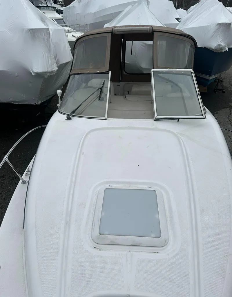 Slide: The Image of 2001 Bayliner 2655 Cierra boat with open cabin windows, docked and covered. - 49