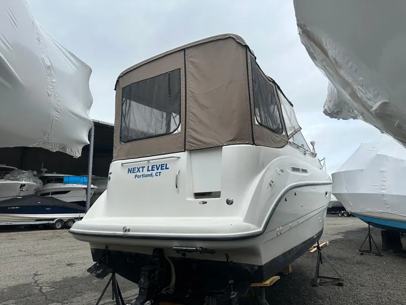 Slide: The Image of 2001 Bayliner 2655 Cierra boat in storage, covered, with "Next Level" name visible. - 6