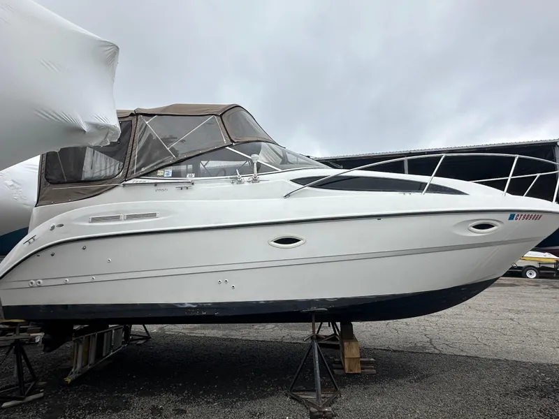 Slide: The Image of 2001 Bayliner 2655 Cierra boat on stands, covered, in a storage area. - 7