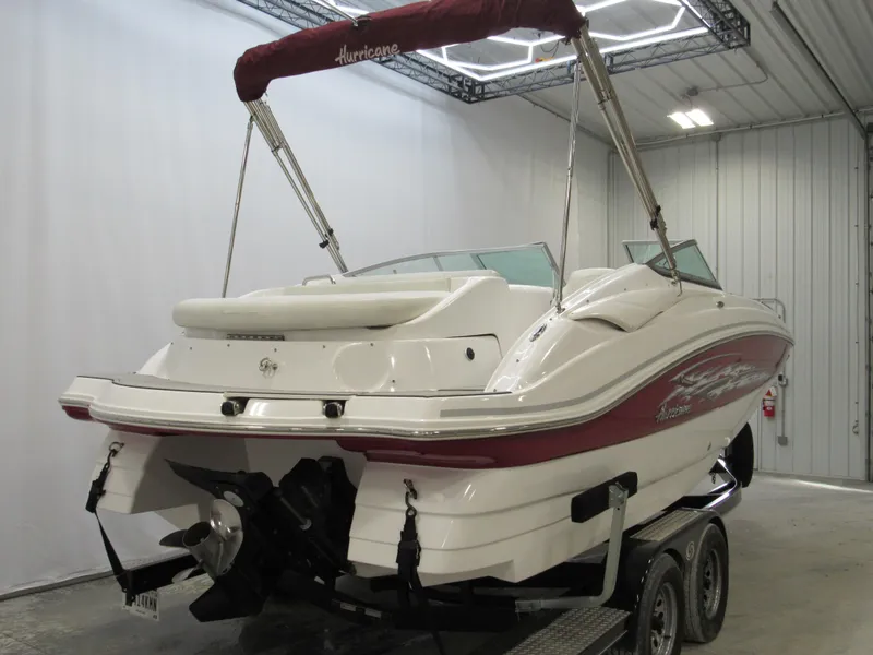 Slide: The Image of 2014 Hurricane SunDeck 2200 IO boat on trailer in indoor storage. - 2