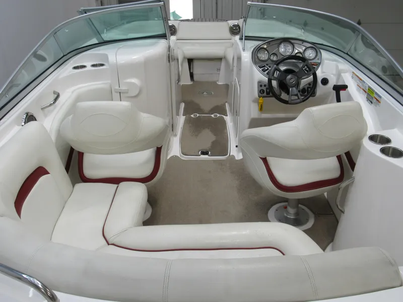 Slide: The Image of 2014 Hurricane SunDeck 2200 IO boat interior with white seating and modern dashboard. - 3