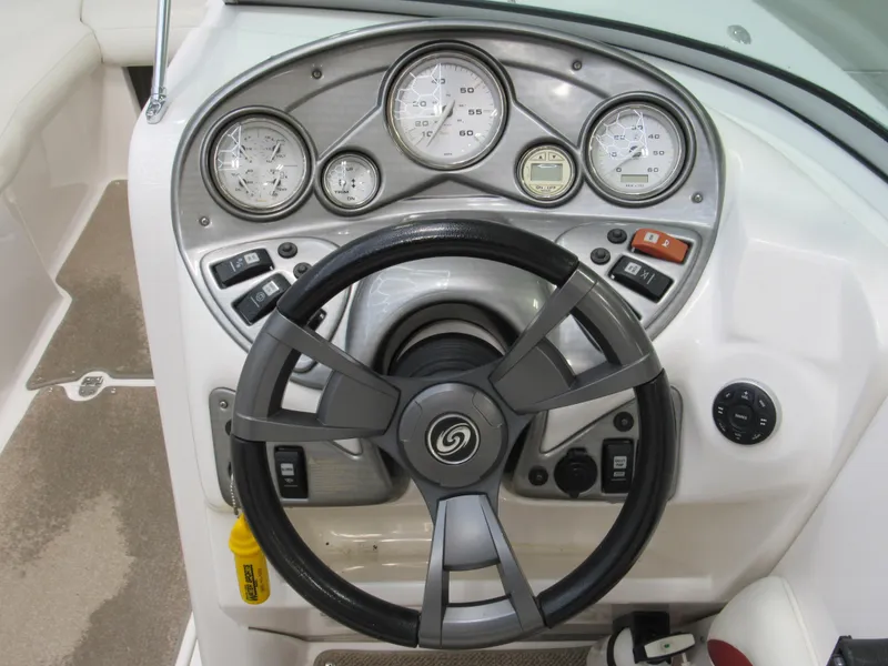 Slide: The Image of 2014 Hurricane SunDeck 2200 IO boat dashboard with steering wheel and gauges. - 5