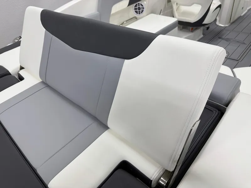 Slide: The Image of 2025 Chaparral 23 SSi boat interior with sleek, modern seating in white and gray tones. - 10
