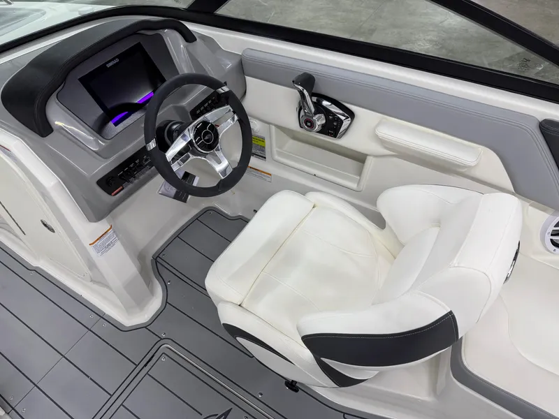 Slide: The Image of 2025 Chaparral 23 SSi boat interior with modern steering and comfortable seating. - 14
