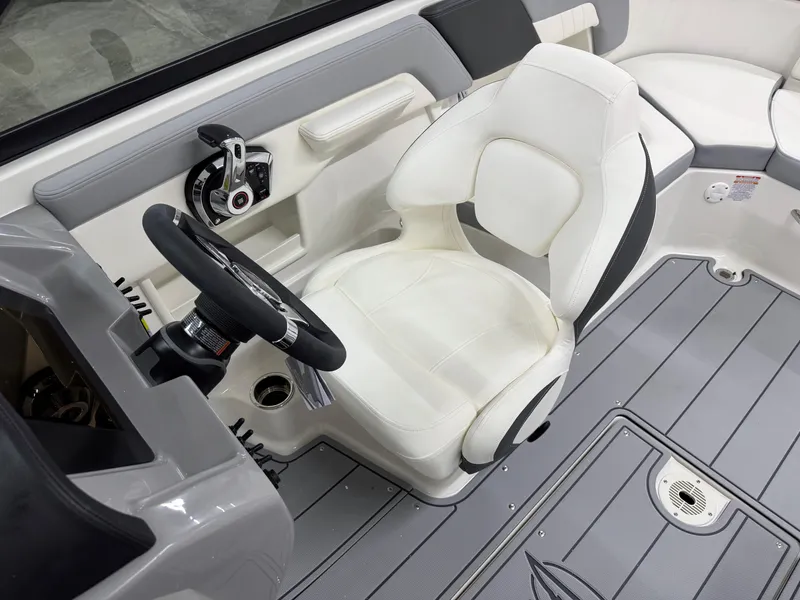Slide: The Image of 2025 Chaparral 23 SSi boat interior with white captain's seat and steering wheel. - 16