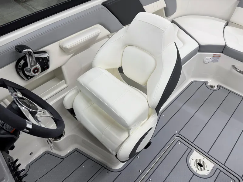 Slide: The Image of 2025 Chaparral 23 SSi boat interior with white captain's chair and steering wheel. - 17