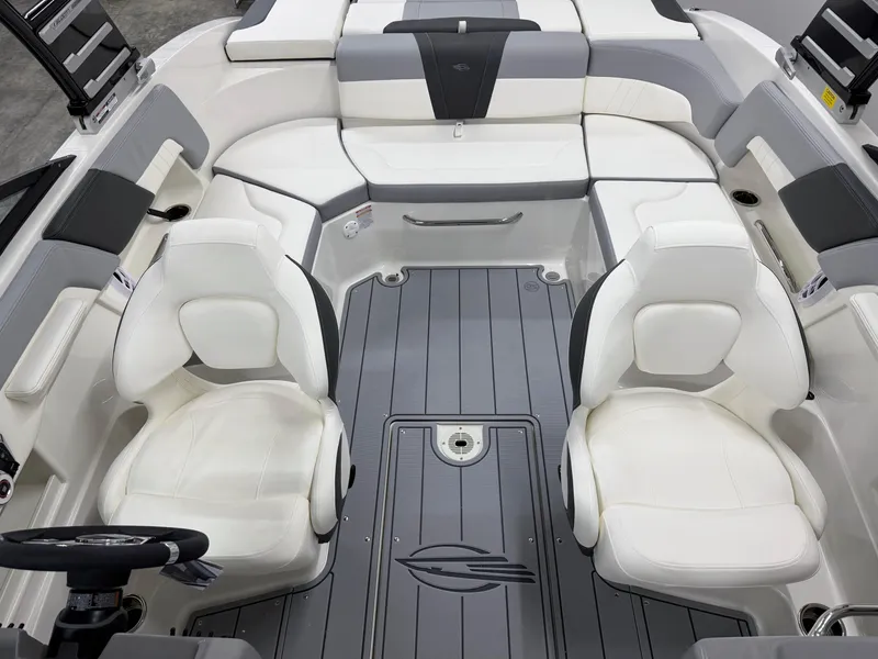 Slide: The Image of 2025 Chaparral 23 SSi boat interior with white seating and gray flooring. - 18