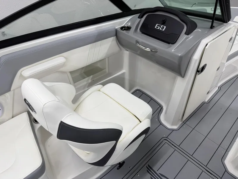 Slide: The Image of 2025 Chaparral 23 SSi boat interior with modern dashboard and comfortable seating. - 19