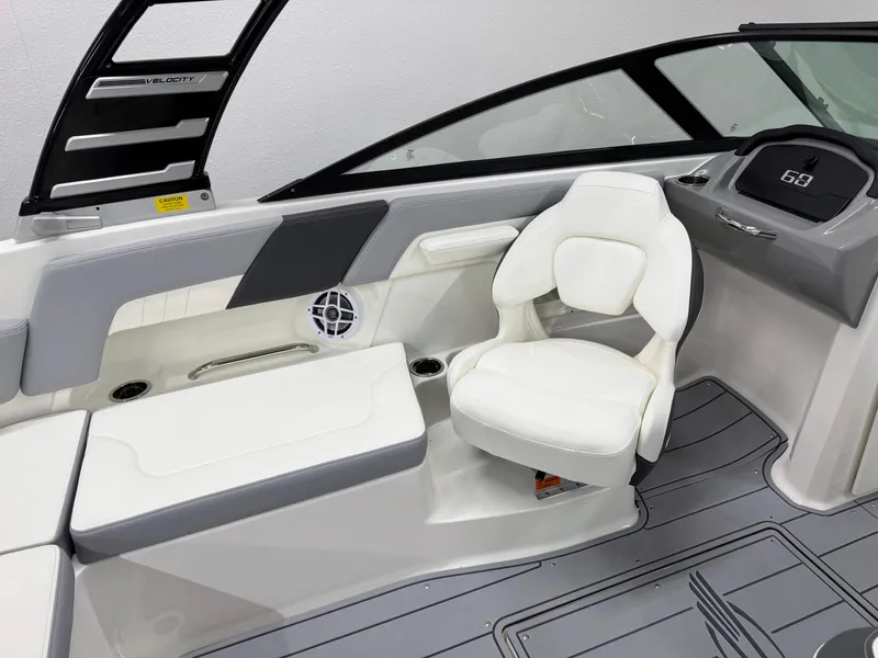 Slide: The Image of 2025 Chaparral 23 SSi boat interior with white seating and modern dashboard. - 24