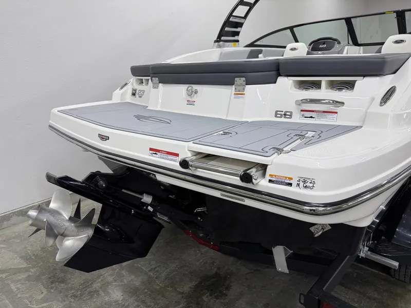 Slide: The Image of 2025 Chaparral 23 SSi boat rear view, showcasing swim platform and dual propellers. - 3