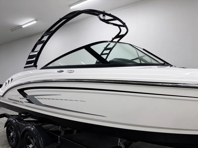 Slide: The Image of 2025 Chaparral 23 SSi boat with sleek design and modern features in showroom. - 31