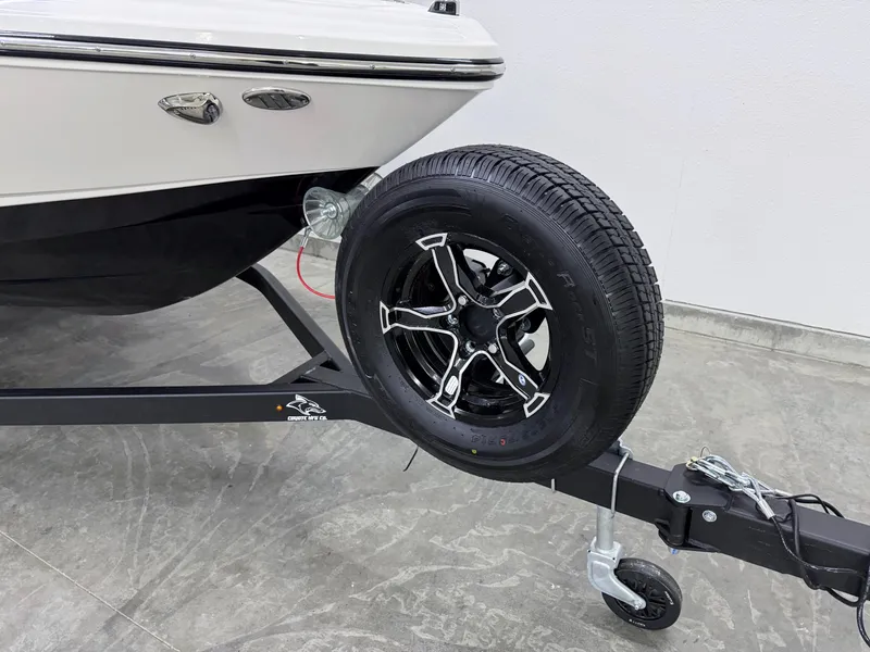 Slide: The Image of 2025 Chaparral 23 SSi boat on trailer with black wheel and silver accents. - 32