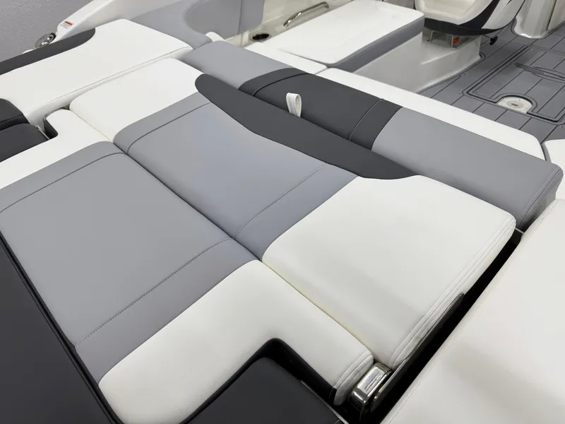 Slide: The Image of 2025 Chaparral 23 SSi boat interior with sleek, modern gray and white seating design. - 8