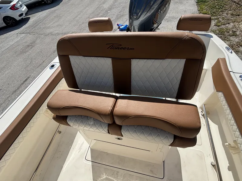 Slide: The Image of 2025 Pioneer 202 Sportfish boat seating with brown and white upholstery. - 10
