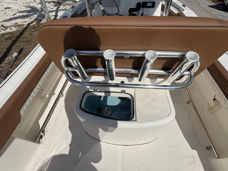Slide: The Image of 2025 Pioneer 202 Sportfish boat interior with rod holders and storage compartment. - 12