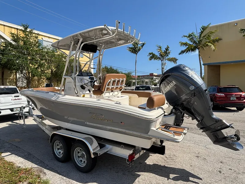 Slide: The Image of 2025 Pioneer 202 Sportfish boat on trailer with Yamaha engine, parked outdoors. - 3
