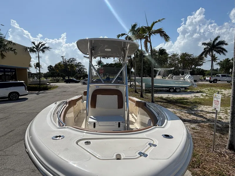 Slide: The Image of 2025 Pioneer 202 Sportfish boat, docked with palm trees and blue sky background. - 4