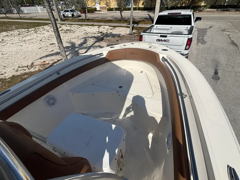 Slide: The Image of 2025 Pioneer 202 Sportfish boat interior with white GMC truck in background. - 6