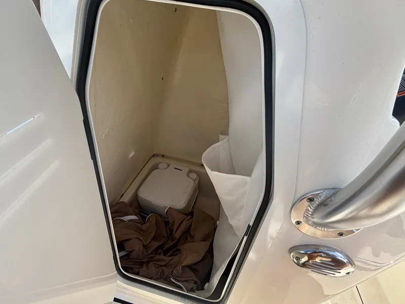 Slide: The Image of Portable toilet inside 2025 Pioneer 202 Sportfish boat compartment. - 7