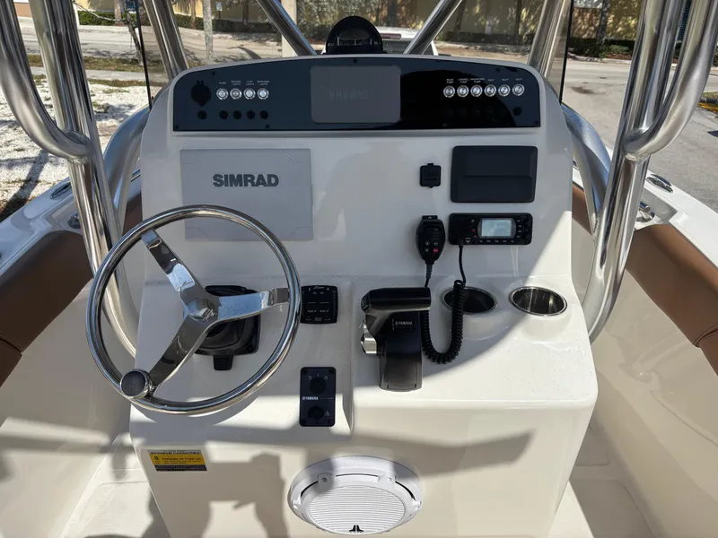 Slide: The Image of Control panel of 2025 Pioneer 202 Sportfish boat with steering wheel and navigation equipment. - 8