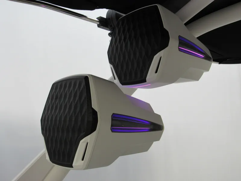 Slide: The Image of Speakers on a 2025 Malibu Wakesetter 24 MXZ boat with sleek design and purple accents. - 11