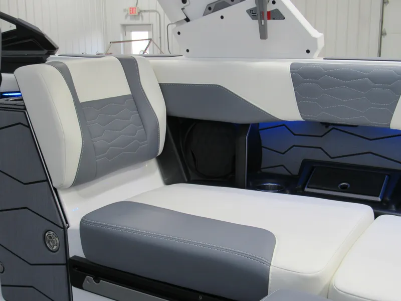 Slide: The Image of 2025 Malibu Wakesetter 24 MXZ interior with gray and white seating, modern design. - 12