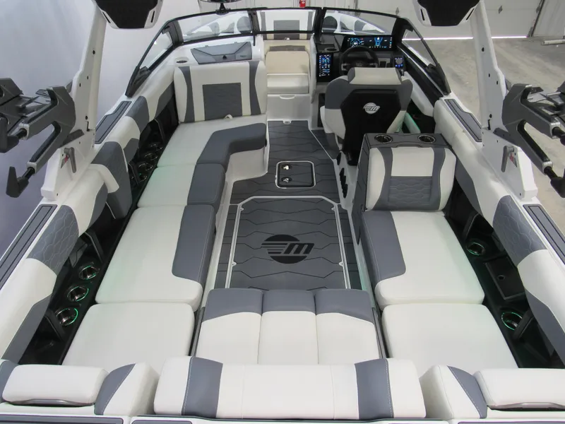 Slide: The Image of 2025 Malibu Wakesetter 24 MXZ interior with luxurious seating and modern dashboard. - 4