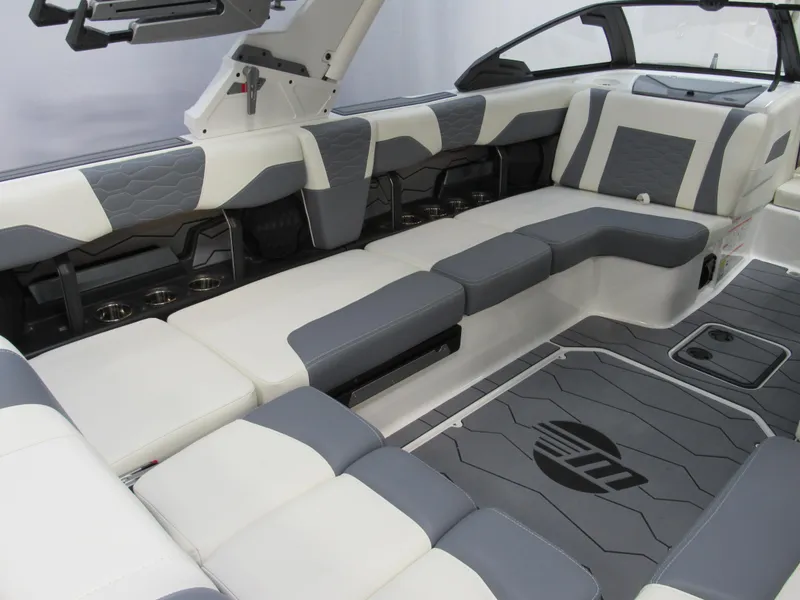 Slide: The Image of 2025 Malibu Wakesetter 24 MXZ interior with gray and white seating, modern design. - 6