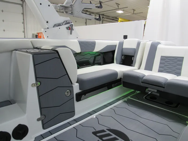 Slide: The Image of Interior of 2025 Malibu Wakesetter 24 MXZ boat with sleek gray and white seating. - 7