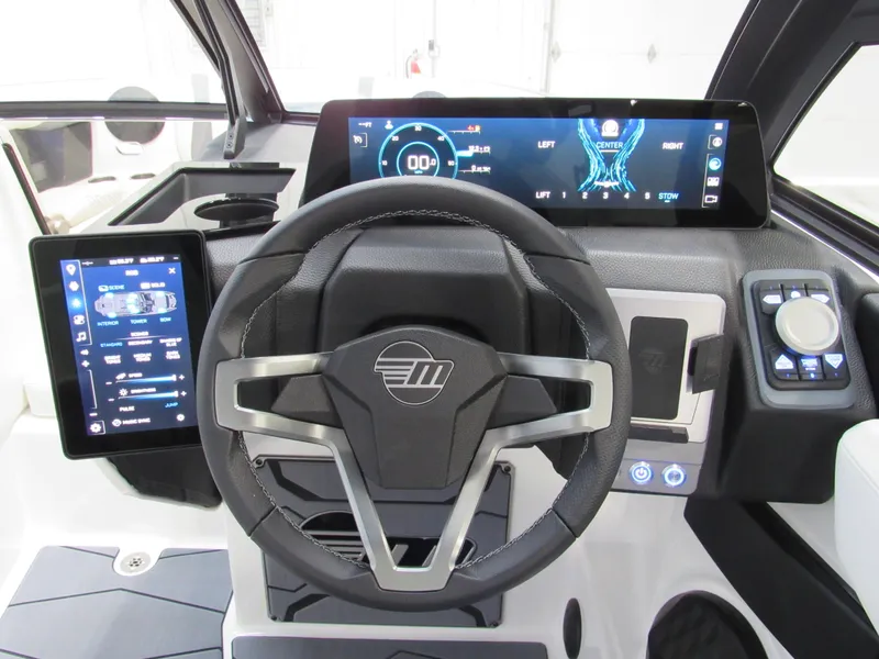 Slide: The Image of 2025 Malibu Wakesetter 24 MXZ dashboard with advanced digital displays and steering wheel. - 8