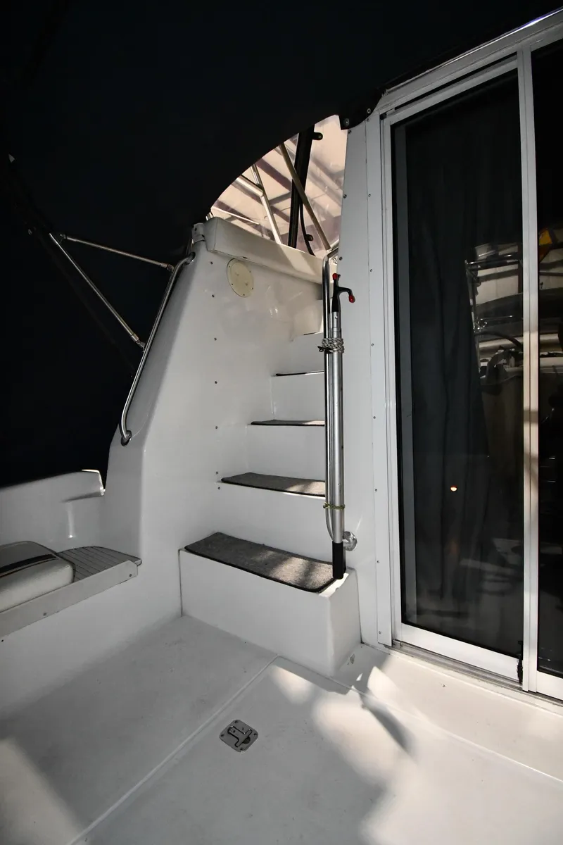 Slide: The Image of 1997 Mainship 40 Sedan Bridge interior stairs with sliding glass door. - 12