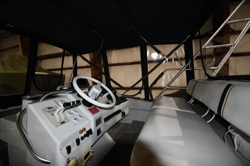 Slide: The Image of 1997 Mainship 40 Sedan Bridge interior with helm and seating area. - 13